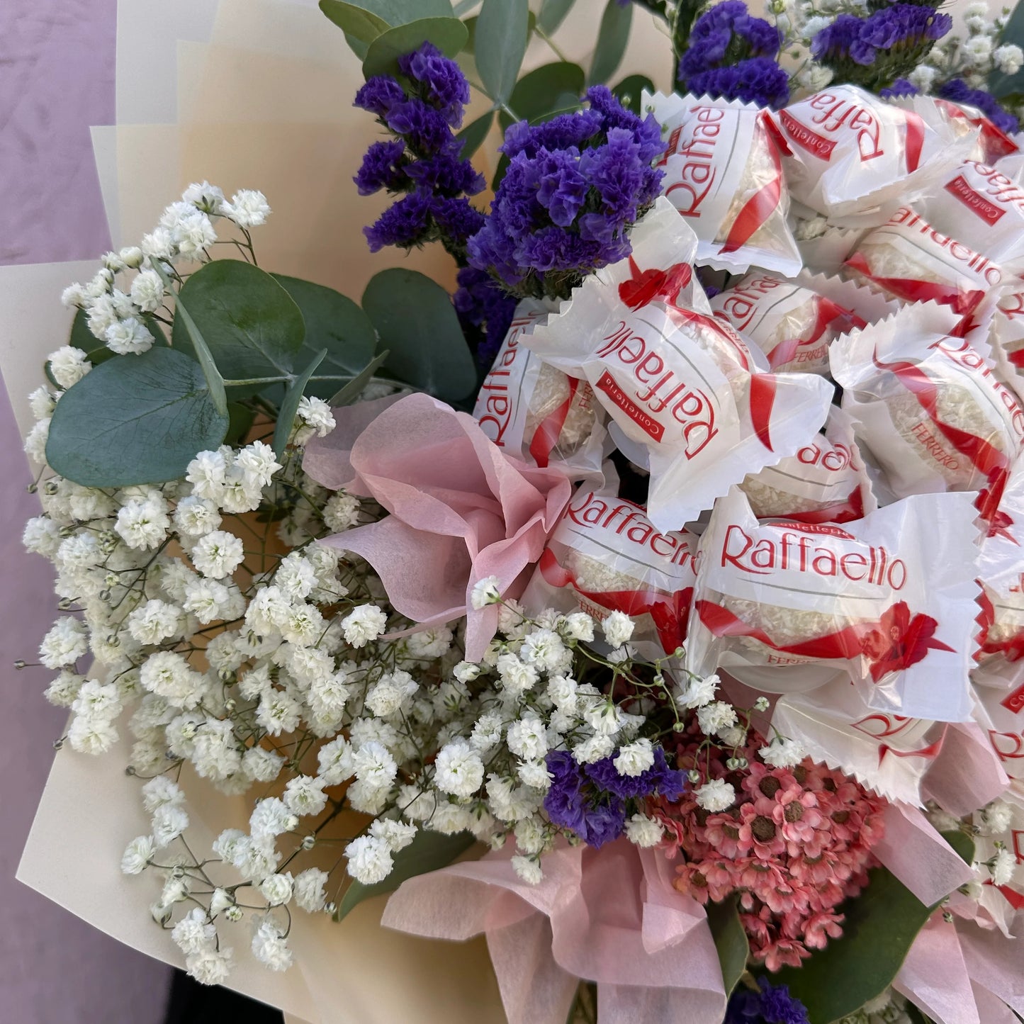 "Raffaello Candy Flower Bouquet," "luxurious flower bouquet," "flower bouquet with chocolates." "unique gift ideas," "flower and candy bouquet," "Raffaello bouquet."